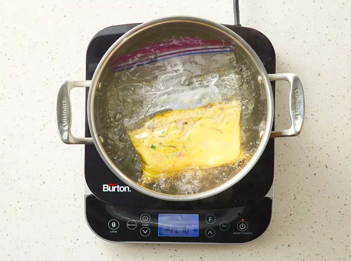 Submerge the sealed bag into the boiling water to cook.