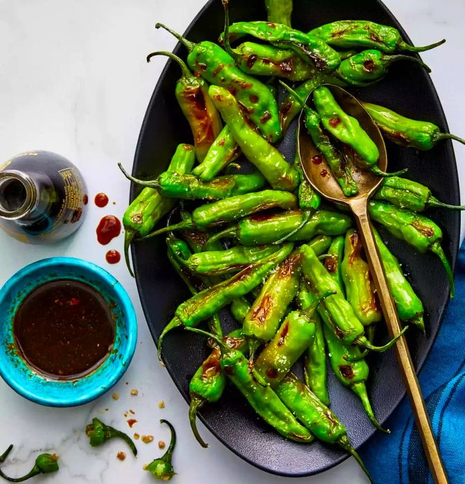 Air Fryer Soy-Ginger Shishito Peppers served on a black plate