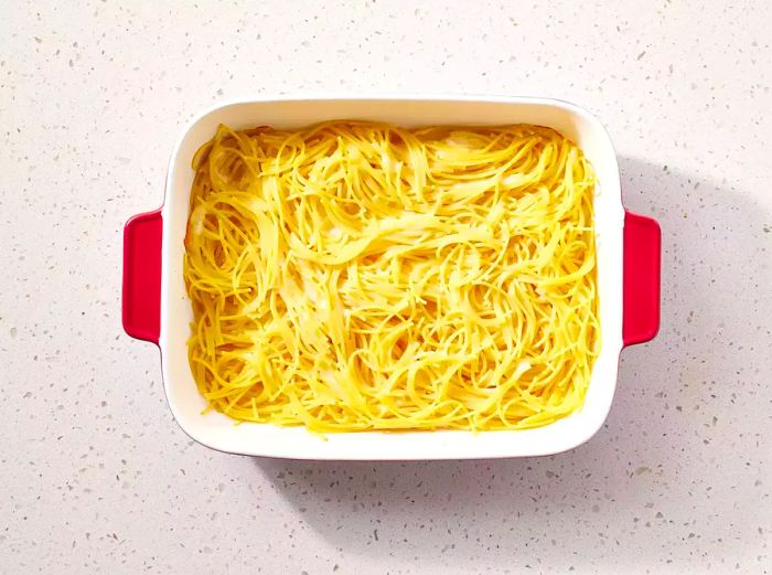 Spaghetti arranged in a casserole dish