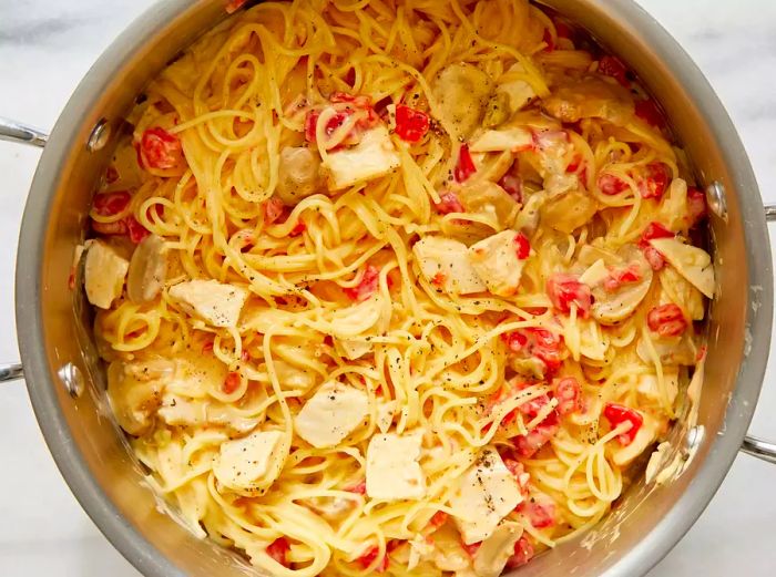 An overhead view of a pot filled with quick and easy chicken spaghetti.