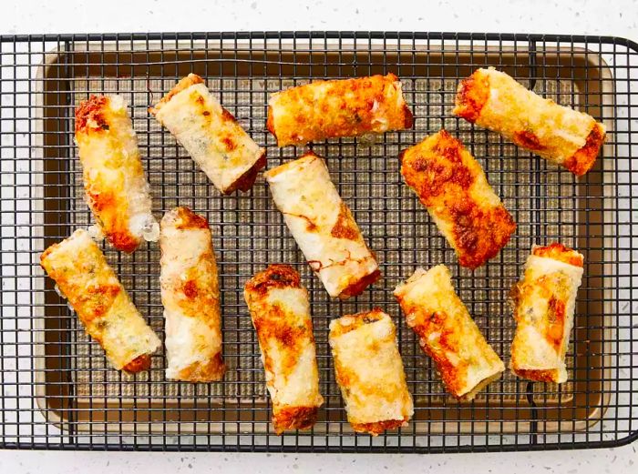 The rolls are fried until they reach a crispy, golden-brown texture.