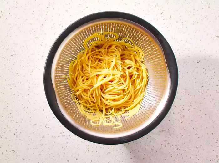 Spaghetti draining in a colander