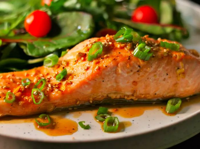 Salmon served with a fresh salad on a plate