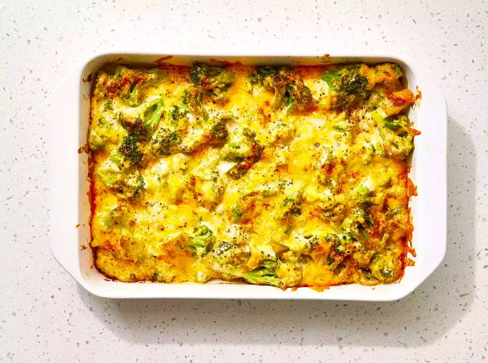 An overhead shot of the delicious broccoli cheese casserole in a white baking dish.