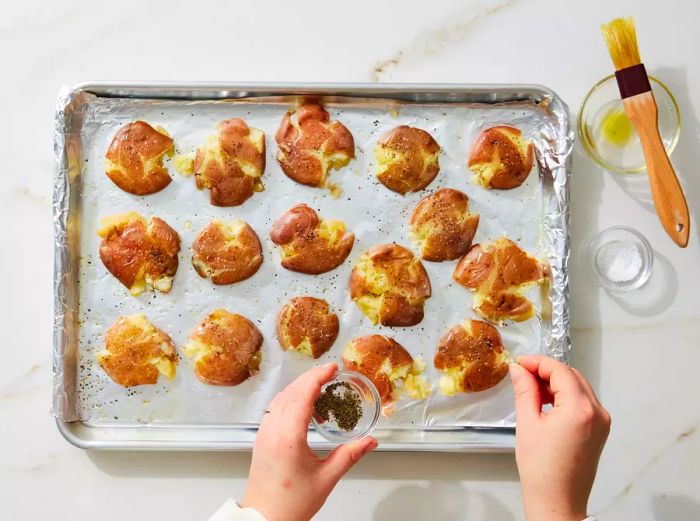 Smashed potatoes seasoned with salt and pepper for flavor.