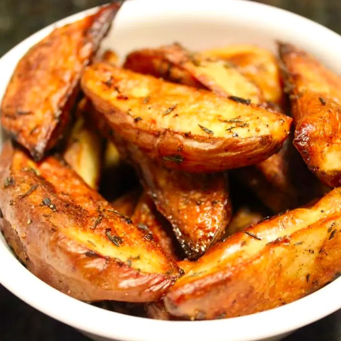 Close-up shot of crispy Duck Fat Steak Fries in a white bowl