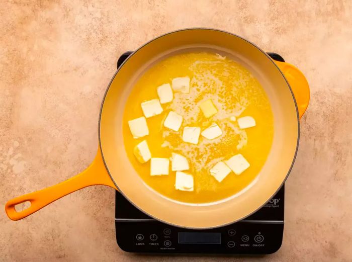 Butter melting in a deep skillet.