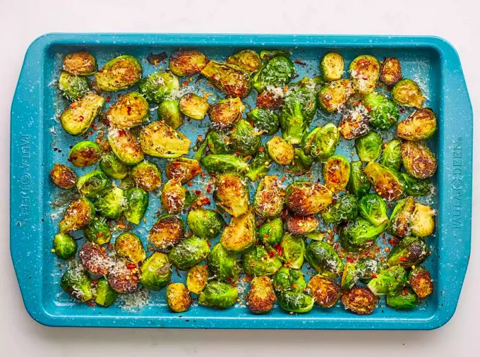 Parmesan-Crusted Roasted Brussels Sprouts on a Blue Baking Dish