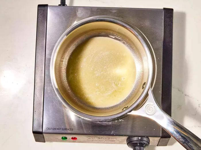 A small saucepan with a roux made of melted butter and flour