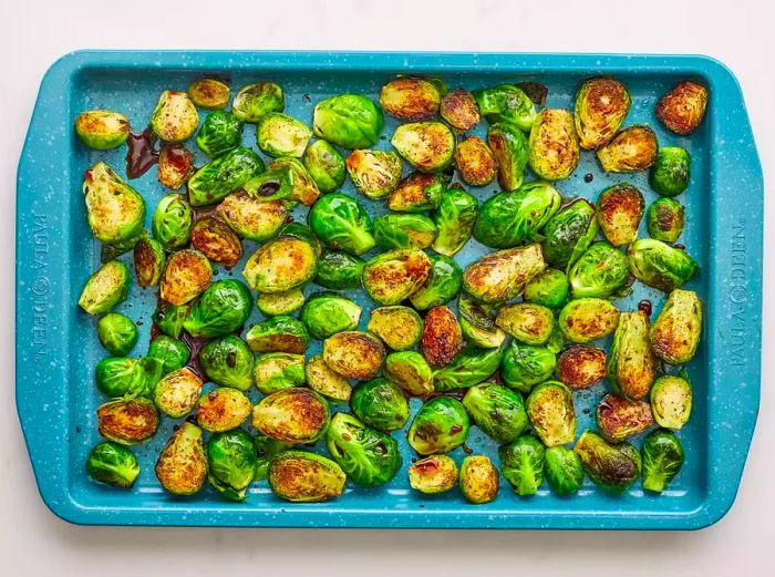 Crispy Roasted Brussels Sprouts in a blue baking dish