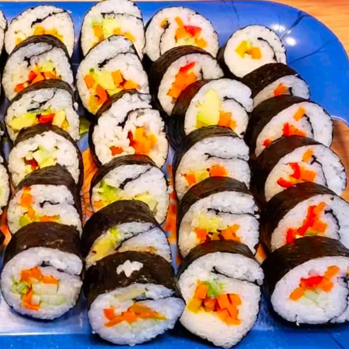 Veggie sushi served on a blue plate