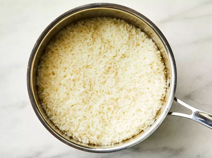 Close-up overhead shot of a pan of cooked rice.