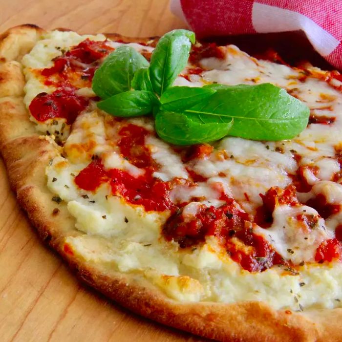 A top-down view of half a lasagna flatbread