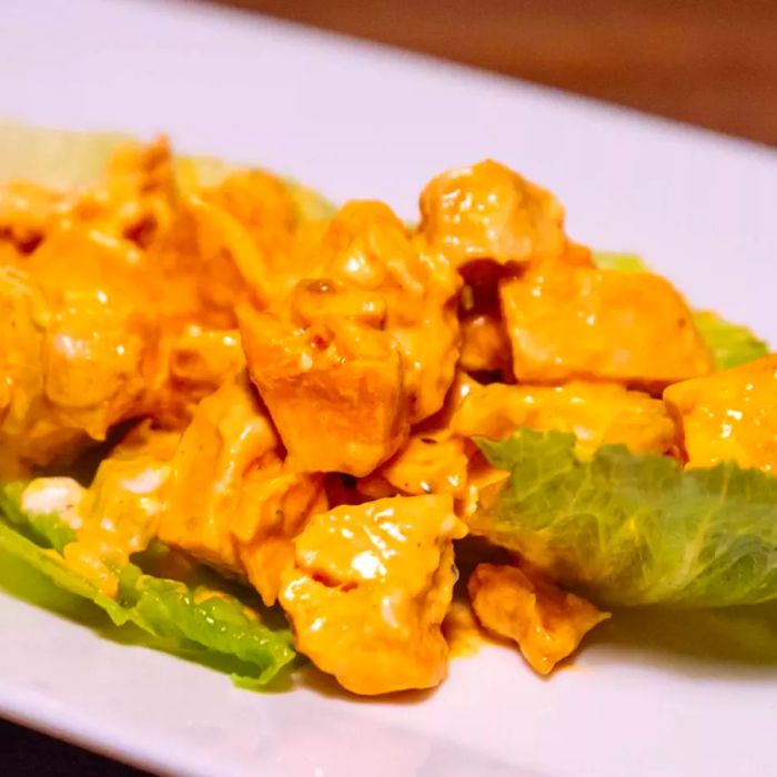 Buffalo chicken served on a bed of lettuce