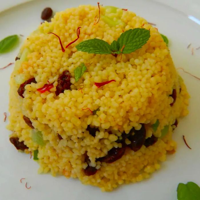 A close-up view of a plate piled high with saffron couscous