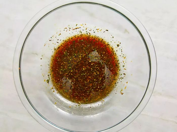 Bird's-eye view of the chicken marinade in a glass bowl.