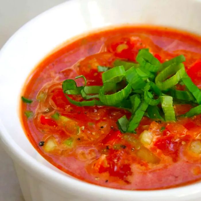 Red gazpacho served in a white bowl