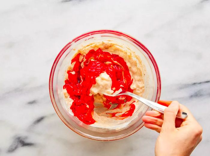 The yogurt mixture ingredients being blended together in a small bowl.