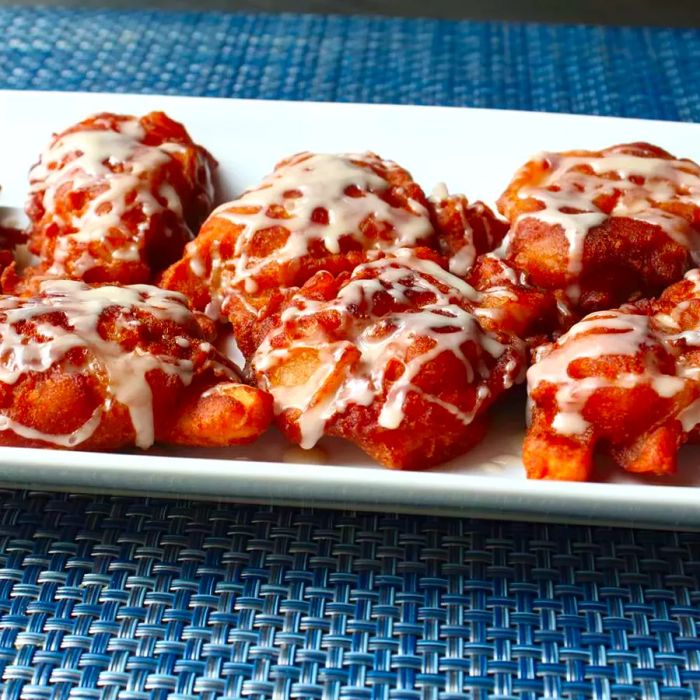 Chef John's crispy, golden apple fritters served on a white dish