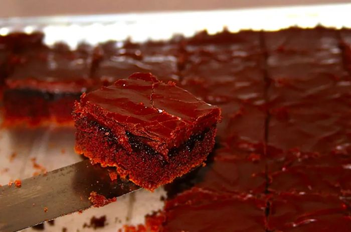 A piece of Texas Sheet Cake being served