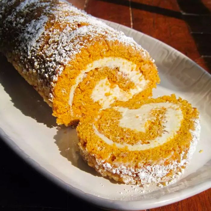 Pumpkin roll cake served on a platter.