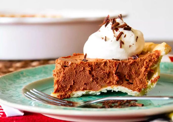 a decadent chocolate pie topped with a layer of fluffy whipped cream