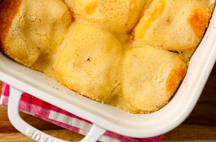 Aerial shot of homemade Mama Rose’s Apple Dumplings recipe in a white baking dish