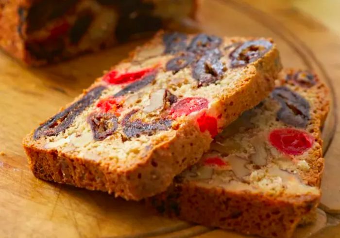 closeup of slices of date nut bread featuring dates and candied cherries throughout