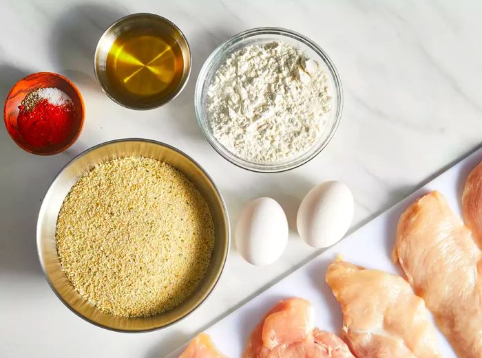 Here are all the ingredients ready for making the baked chicken schnitzel.