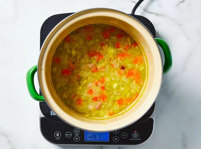 Vegetables simmering in the pot until they are tender.