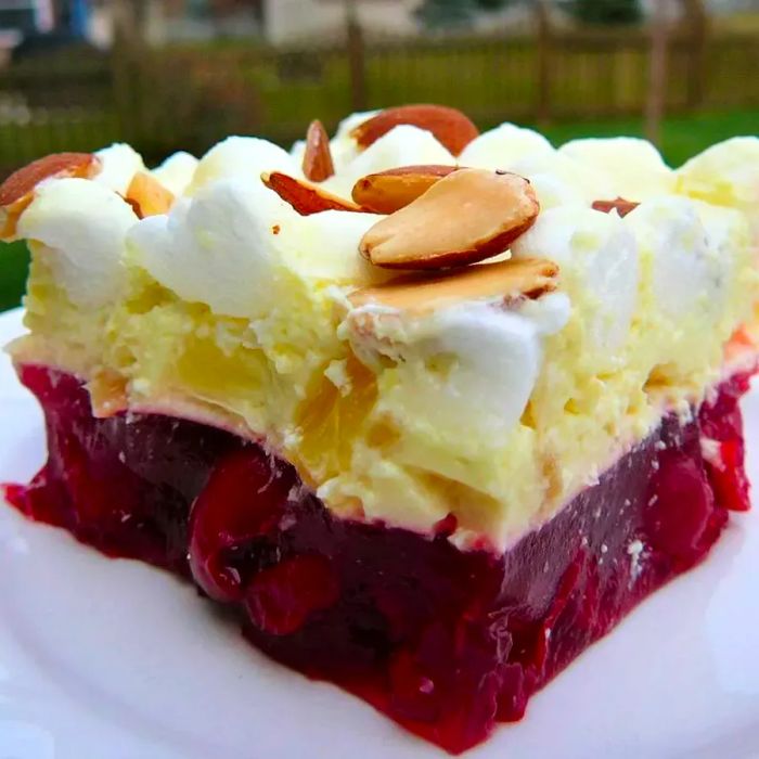 A slice of Cherry Supreme Salad, a Jell-O-based dessert