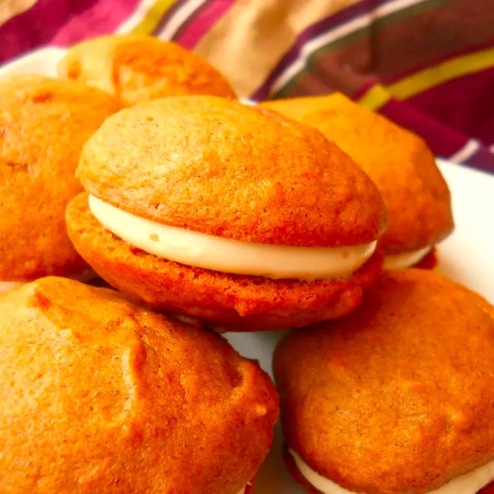 Pumpkin Whoopie Pies served on a white plate.