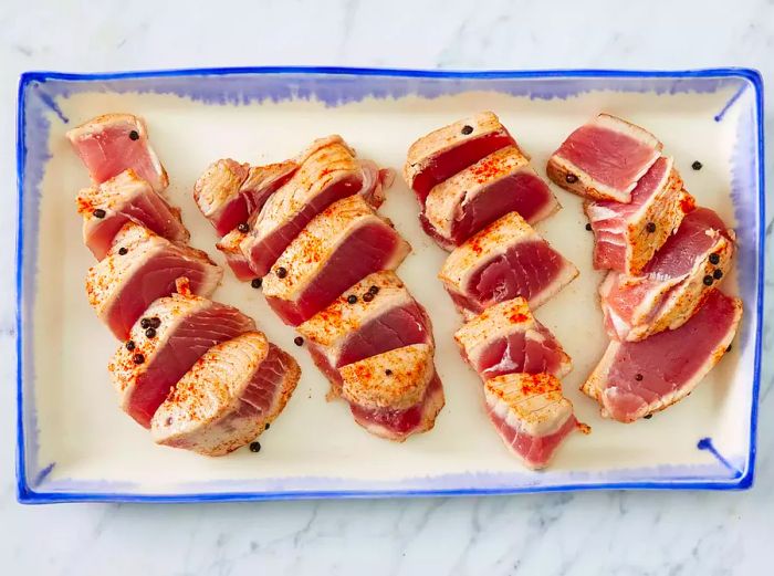 A platter holding fifteen perfectly cooked tuna steaks