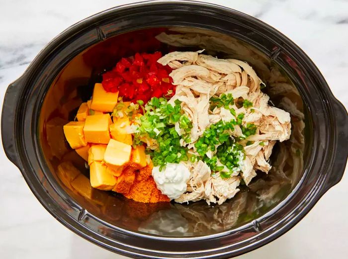 Ingredients mixed together in a slow cooker.