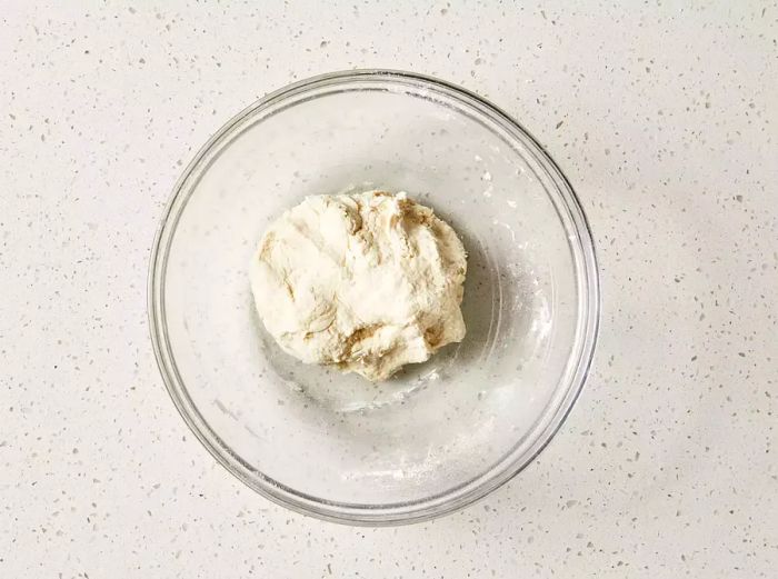 Flour, olive oil, and salt mixed in until the dough detaches from the bowl’s edges.