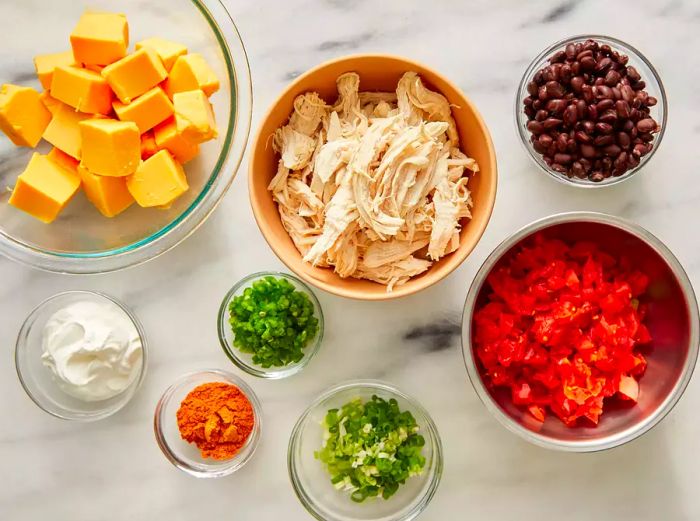 All ingredients ready to create the irresistibly warm chicken nacho dip.