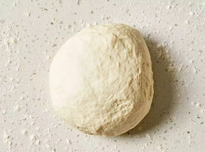 Dough placed onto a floured surface and kneaded until smooth.