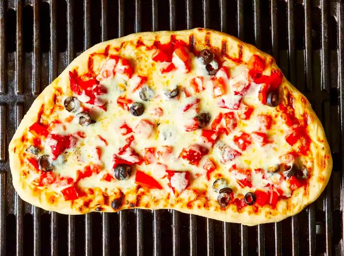 Cook the pizza until the cheese is fully melted.