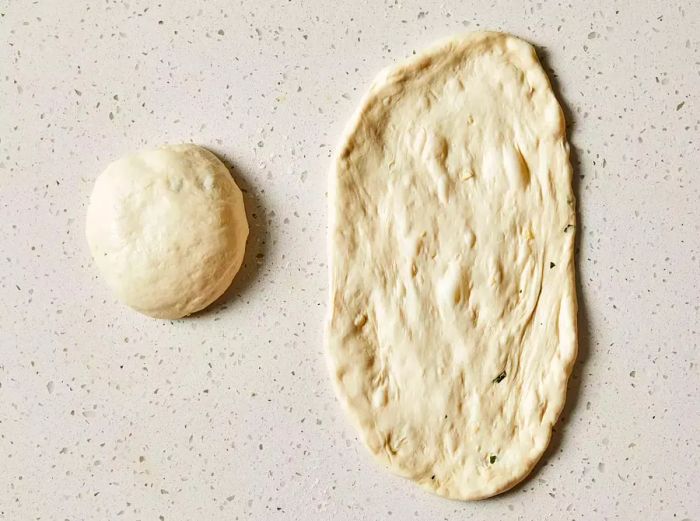 The dough is divided into two halves and shaped into an oblong form.