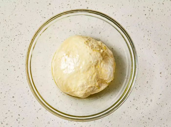 Dough placed in a greased bowl.