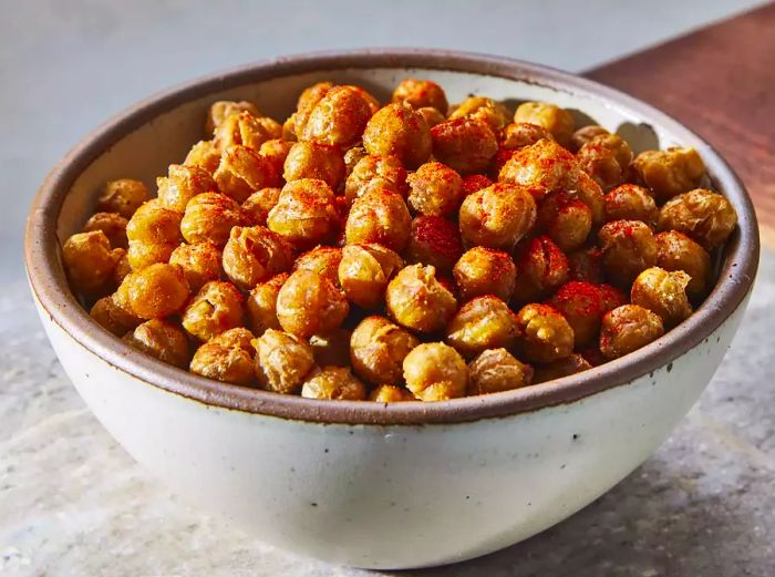 Close-up view of a bowl filled with roasted chickpeas.