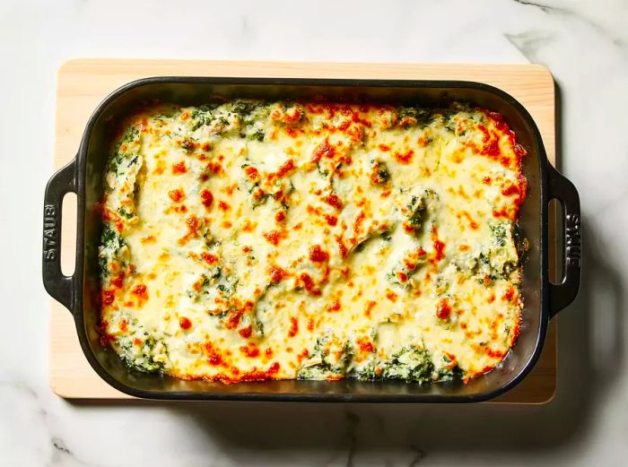 The chicken and spinach casserole is baked until golden and bubbling.