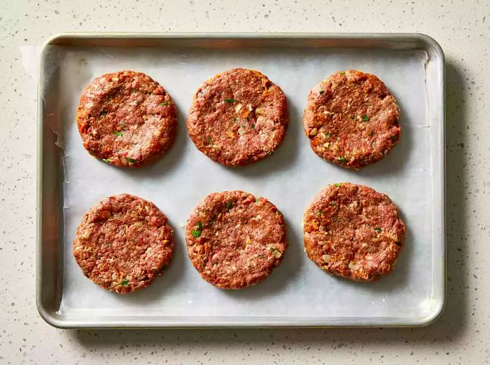 Venison bacon burgers shaped into six even patties.