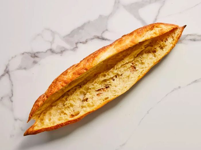 A whole baguette, toasted and sliced in half