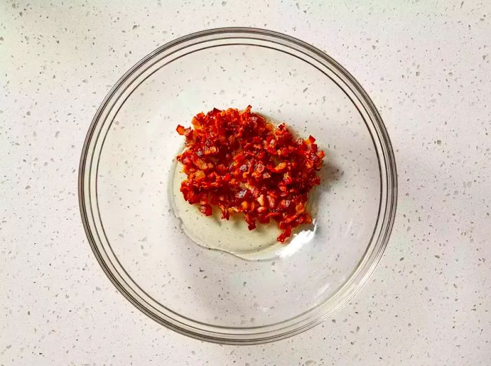 Bacon and grease transferred into a heat-resistant bowl.