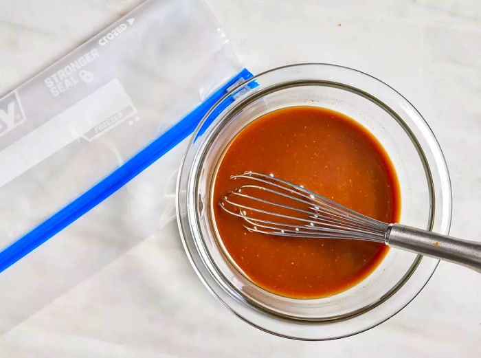 Aerial shot of miso and soy marinade being whisked together in a bowl.