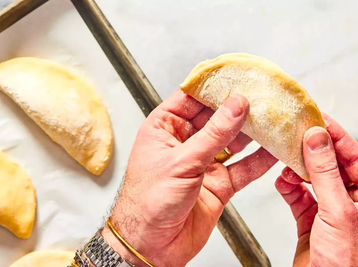 half-moon shaped pierogi with edges pinched to seal