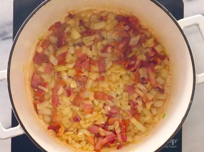 Bacon and onions sautéing in a stockpot