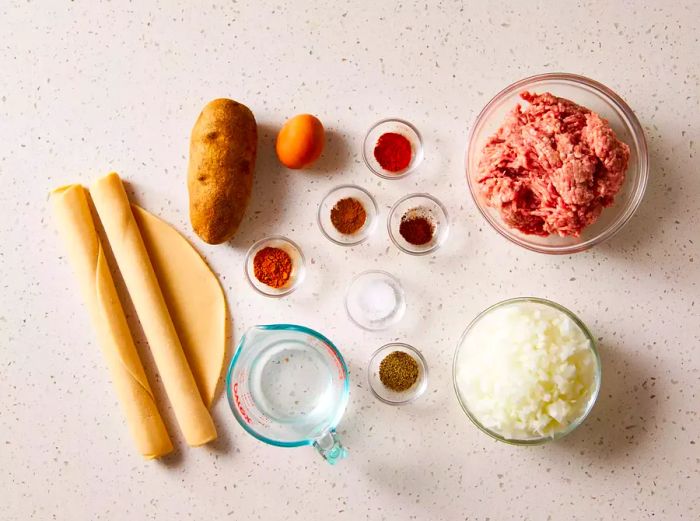 Ingredients for Tourtière (French Canadian Meat Pie) arranged on a countertop