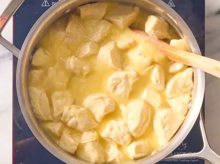 Biscuits quartered and mixed into the simmering soup